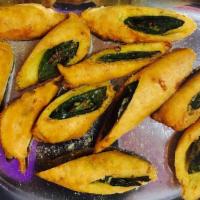 Cut Mirchi · Sliced chili bajjis, deep-fried, toped with chat masala, onions, & lemon. Served with fresh ...