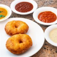 Medhu Vada (2 Pieces) · Fried lentil flour doughnuts. Served with fresh chutneys & sambar.