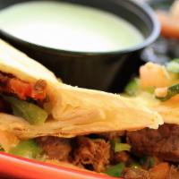 Fajita Chimichanga · Grilled chicken or steak, onions, and peppers rolled inside a tortilla and lightly fried, co...