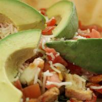 Chicken Avocado Salad · Grilled chicken, peppers and onions. served in a crispy tortilla bowl with salad greens, tom...