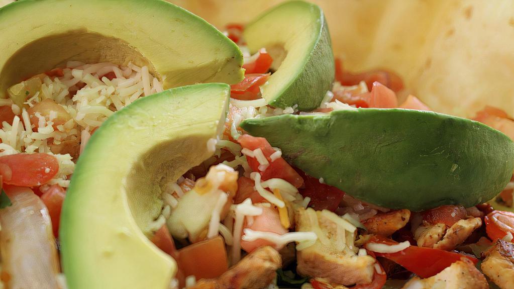 Chicken Avocado Salad · Grilled chicken, peppers and onions. served in a crispy tortilla bowl with salad greens, tomatoes, monterey jack cheese, and sliced avocados. served with a side each of jalapeño ranch dressing and salsa ranchera.