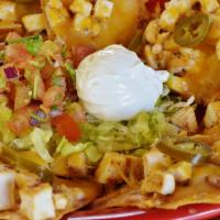 Fajita Nachos · Grilled chicken or steak layered on corn tortillas topped with cream cheese, refried beans, ...