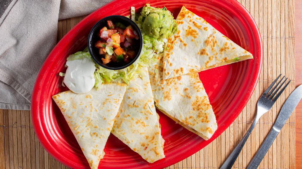 Shrimp Avocado Quesadilla · Grilled Shrimp, Monterey Jack cheese and avocados grilled in a large flour tortilla, served on a bed of fresh lettuce with guacamole, pico de gallo and sour cream.