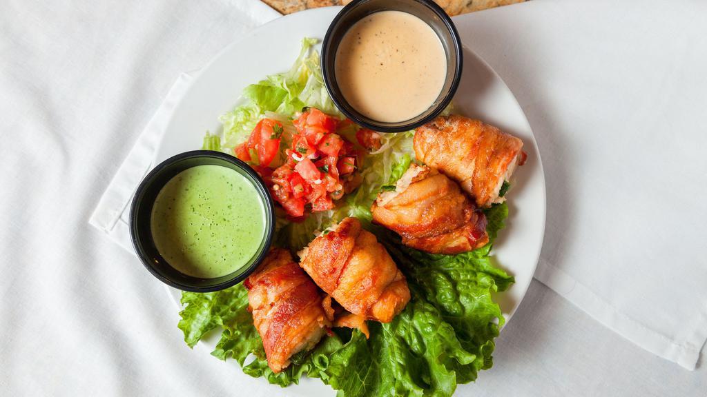Cancun Chicken · Hickory smoked bacon, wrapped around fresh chicken tenderloin, stuffed with a slice of fresh jalapeño, pepper jack cheese and grilled to perfection. Served with Crema de Chipotle and Crema de Jalapeño sauces for dipping.