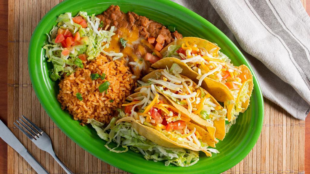 Deep Fried Tacos (3) · Crispy corn tortillas filled with choice of ground beef, machaca beef, or seasoned chicken, lettuce, tomatoes, and cheese. served with refried beans and rice.