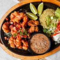 Cancun Shrimp Fajitas · Twelve large bacon-wrapped jalapeno and cheese stuffed shrimp, accompanied with lettuce, pic...