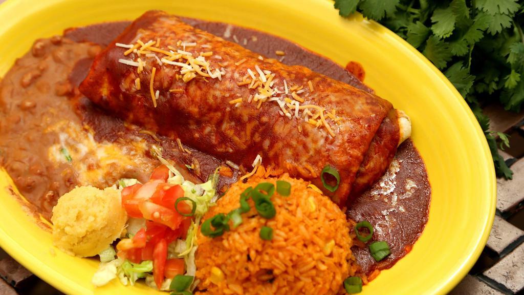 Nuevo Burrito · Choice of seasoned chicken, ground beef or machaca beef with refried beans, and cheese rolled inside a flour tortilla, then covered with enchilada sauce and cheese and baked, served with rice.