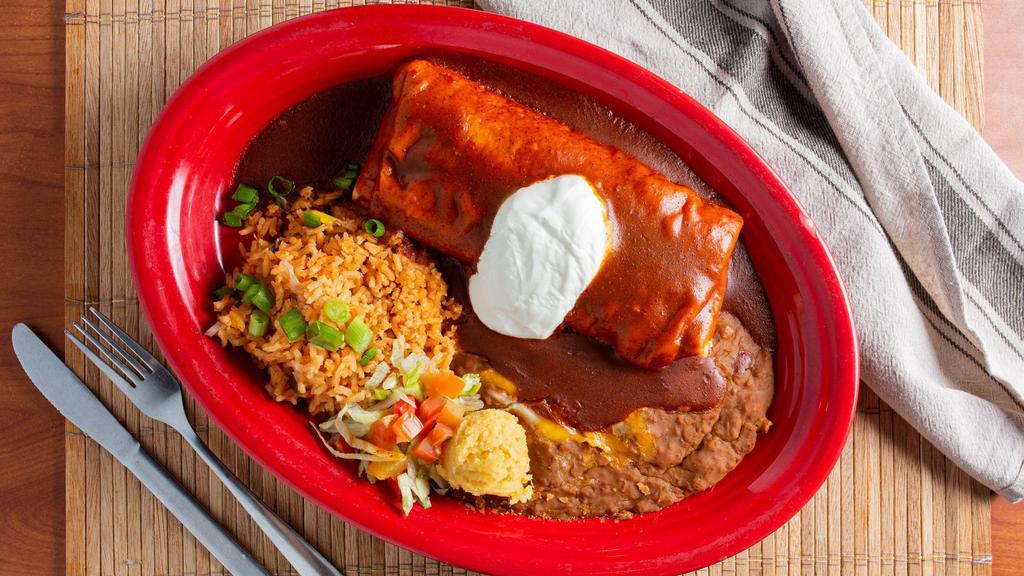 Chimichanga Tradicionales · A lightly fried tortilla filled with your choice of: seasoned all white meat chicken, pork carnitas, ground beef, or shredded machaca beef. All served with refried beans, rice, & topped with sour cream.
