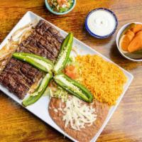 Carne Asada · Grilled steak with jalapeños and grilled onions. Served with rice, beans, lettuce, tomato an...