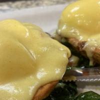 Potato Skin Benedict · Crispy bacon, hollandaise sauce on a bed of spinach.