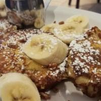 Pecan Roll French Toast · Dusted with cinnamon and powdered sugar, topped with banana and drizzled with honey.