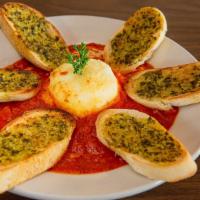 Baked Goat Cheese · Goat cheese baked in a bed of marinara served with pesto toast points