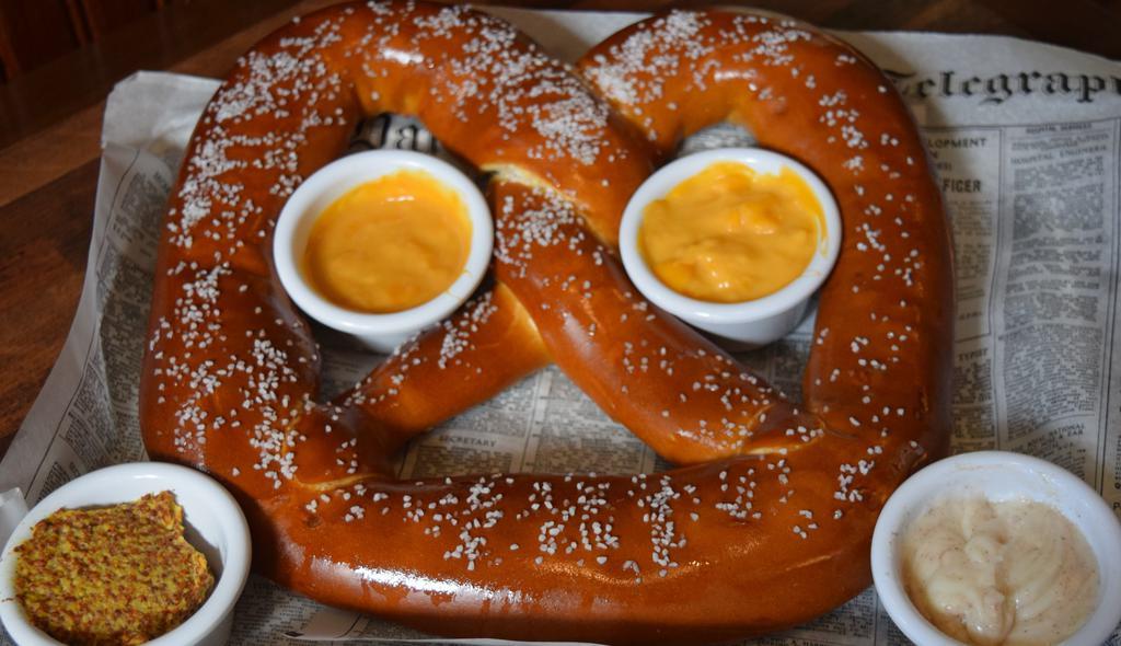 Saz'S Big Pretzel · Big enough to share! One-pound salted pretzel served with Bavarian beer mustard, beer cheese, nacho cheese and cinnamon icing.