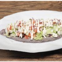 Tlacoyos Braised Pork · Served with lettuce, tomato, onion, cheese and sour cream.