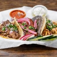 Tacos Filet Mignon · Onion and cilantro, with a small side of cucumber and radish