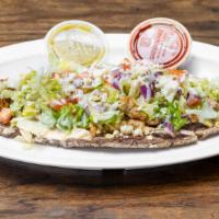 Tlacoyos Mexican Chorizo · Served with lettuce, tomato, onion, cheese and sour cream.