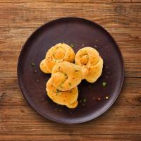 Garlic Knots · Savory bite sized tender dough twists slathered in garlic olive oil and baked golden brown w...