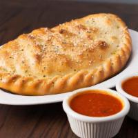 Calzone · Mozzarella cheese wrapped with butter-brushed dough, sprinkled with Parmesan and oregano, th...
