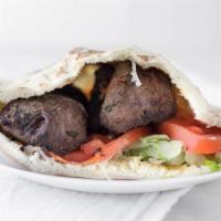 Beef Kabob Wrap · Grilled pieces of marinated tender beeF  with hummus, lettuce, tomato, onions, pickles and t...