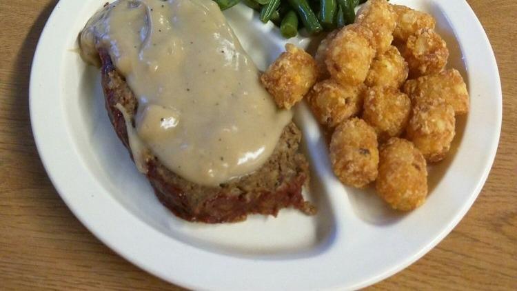 Homemade Meatloaf · Smothered in gravy.
