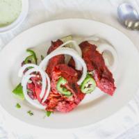Tandoori Chicken · Marinated in yogurt and spices overnight, cooked in tandoor oven. 1/2 Chicken Cut into 4 Pie...