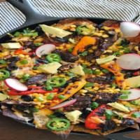 Steak Nachos Supremo · Steak nachos Mexican appetizer the dish has tortillas that are stuffed with tender and juicy...