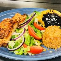 D-Chipotle Salmon · Grilled Salmon topped with a chipotle garlic sauce. Served with black beans and Spanish rice.