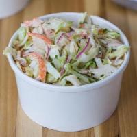 Farm Slaw · Fresh cut cabbage, carrots, green onions, red onions, chopped parsley in. our not too creamy...