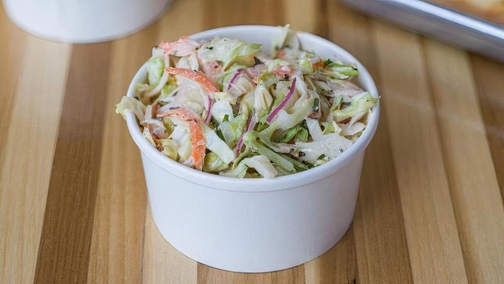 Farm Slaw · Fresh cut cabbage, carrots, green onions, red onions, chopped parsley in. our not too creamy, not too tangy house-made coleslaw dressing