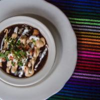 Black Bean Soup · Hearty black beans, simmered with fresh epazote, topped with spicy chipotle sauce, sour crea...