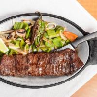 Carne Asada · A tender juicy skirt steak char-boiled to perfection. Served with scrumptious grilled veggie...