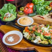 Mixed Fajitas · Steak and chicken. Sizzled in a succulent white wine marinade with onions, peppers and tomat...