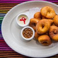 Donitas · Donitas mexicanas, bite sized donuts tousled in a cinnamon sugar blend. Served with a decade...