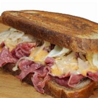 Reuben Sandwich · A Classic. Corned Beef Reuben.

Corned beef on marbled rye grilled and topped with sauerkrau...