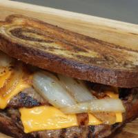 Patty Melt · A classic patty melt sandwich

two burger patties flame grilled on marbled rye bread
Topped ...