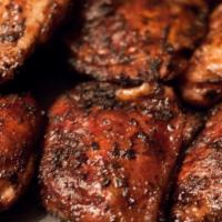 Jerk Chicken Dinner · Grilled Jerk chicken with Jamaican Jerk Sauce served with Cole slaw and Baked Beans.