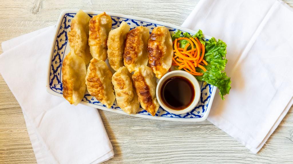 Pot Stickers · Ground pork cabbage, green onion, ginger, egg, salt, sesame oil served with soy sauce on the side.