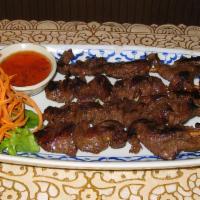 Thai Bbq Beef · Beef marinated with Thai herbs on a stick, grilled to perfection served with chili.