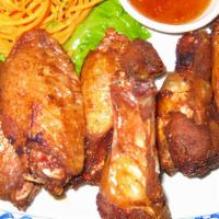 Fried Chicken Wings · Marinated chicken wings deep-fried and served with sweet chili sauce