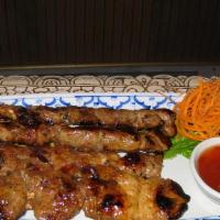 Thai Bbq Pork · Pork marinated with Thai herbs on a stick, grilled to perfection served with chili sauce.