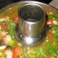 Pho Tak Seafood Hot Pot · Hot and sour soup with combination seafood and mushroom, lemon grass, tomatoes, lime juice.