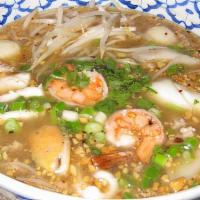 Tom Yum Seafood Noodle · Hot and spicy rice noodle soup with combination of seafood, ground pork and ground peanuts.