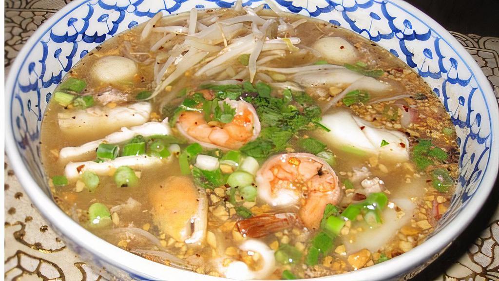 Tom Yum Seafood Noodle · Hot and spicy rice noodle soup with combination of seafood, ground pork and ground peanuts.
