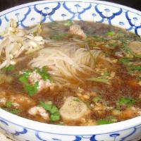 Thai Bbq Pork Noodle Soup · A large bowl of rice noodles soup with rare slice of pork, well done pork, and pork ball.