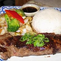 Thai Bbq Steak · Fresh selected steak marinated with Thai spices, grilled perfection served with sautéed vege...
