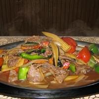 Siam Sizzling · Spicy. Choice of chicken, beef, pork, or substitute for shrimp, with mushroom, onion, baby c...