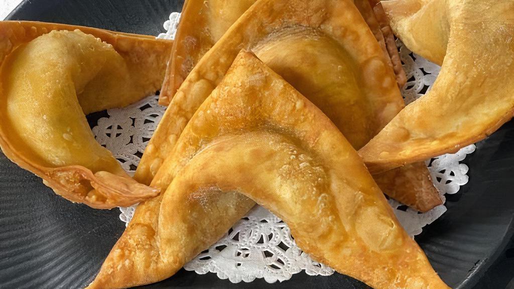Crab Rangoon · A rich and creamy blend of imitation crabmeat, cream cheese, and light green onion wrapped in wonton sheet deep-fried to golden perfection.