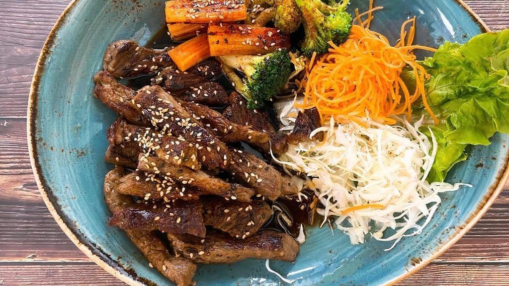 Beef Teriyaki · Grilled sliced beef topped with homemade sweet & tangy teriyaki sauce and sesame seeds. Served with steamed broccoli and carrot