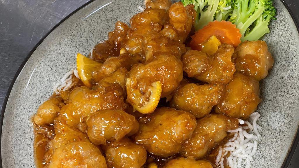 Orange Peel Chicken · Crispy chicken tossed with a sweet & tangy orange sauce and fresh orange peel. Served with steamed broccoli and carrot