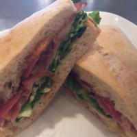 Ham Ciabatta · Smoked ham, salami, prosciutto with tomato, roasted onions, forest greens, cheddar cheese, s...